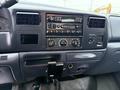 Dashboard of a 2001 Ford F-350 featuring a radio and climate controls with various knobs and buttons