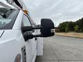 A white 2018 Ford F-550 with a prominent side mirror featuring a chrome accent
