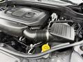 2019 Jeep Grand Cherokee engine compartment featuring a black engine cover and various components including hoses and an air intake system