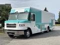 A 2020 Freightliner MT45 food truck with a turquoise and white exterior featuring large windows and side access door