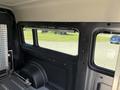 Interior view of a 2021 RAM Promaster featuring a large window with a sleek black frame and reflective aluminum paneling on the sidewall
