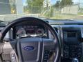 The interior of a 2014 Ford F-150 showing the steering wheel dashboard and control panel with various gauges and buttons