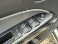 Close-up of the control panel on the driver's side door of a 2018 Chevrolet Colorado featuring window and lock buttons in a sleek black finish