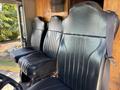 Interior of a 2008 Workhorse W62 featuring four black vinyl seats with vertical ribbed detailing and seat belts