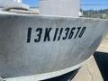 Aluminum 16 foot boat with a weathered surface displaying the numbers 13KII3670