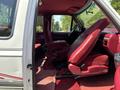 A 1995 Ford F-250 with a red interior featuring bucket seats and a visible steering wheel in the driver's side cabin