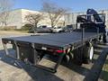 A 2015 Hino 358 flatbed truck featuring a black bed and rear lights with a simple design ready for loading cargo