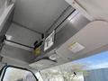 Interior view of a 2012 Ford Econoline E-450 dashboard showing an overhead console with controls and storage compartments