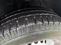 Close-up of a tire from a 2016 Mercedes-Benz Sprinter showing detailed tread pattern and slight wear on the rubber surface