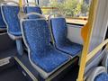 Interior view of a 2016 Grande West Vicinity bus showing blue patterned seats with ergonomic design and handrails