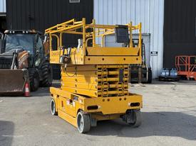 A yellow 2013 Haulotte Compact scissor lift with raised platform and guardrails featuring multiple sections for height adjustment