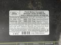 A 2012 Ford Econoline with an engine information label detailing regulations and fuel tank capacity