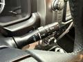 A close-up image of the steering column controls in a 2018 Toyota 4Runner showing various buttons and levers for wipers and lights