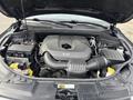 A 2015 Dodge Durango engine with a V6 configuration showing various components including the air intake, battery, and coolant reservoir