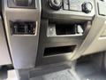 Interior console of a 2017 Ford F-550 featuring controls for air conditioning and additional storage compartments