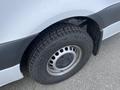 A close-up of the wheel and tire of a 2025 Mercedes-Benz Sprinter showing the tread pattern and silver wheel rim