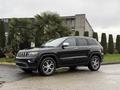 A 2019 Jeep Grand Cherokee in black with chrome accents and alloy wheels parked at an angle displaying its sporty design and spacious build