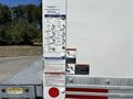 Close-up of a Hino 338 truck with operating and safety instruction labels attached to the side of the vehicle