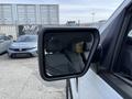 A side mirror of a 2021 Ford F-150 showing its sleek design and reflective surface