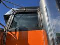 A close-up of a 2009 Peterbilt Highway truck's side window and door featuring chrome details and an orange panel