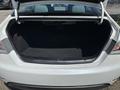 A 2014 Hyundai Sonata with an open trunk showcasing a spacious empty interior
