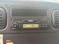 Dashboard of a 2006 Freightliner M2 106 featuring a radio unit with buttons display and a clock showing the time as 154 PM