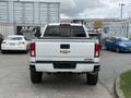 A white 2017 Chevrolet Silverado 1500 viewed from the rear showing the tailgate and back bumper with the logo visible