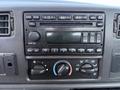 Dashboard of a 2008 Ford F-750 featuring a radio and climate control knobs