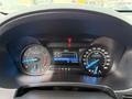The dashboard of a 2019 Ford Explorer displaying speedometer and tachometer dials along with a digital screen showing trip information and fuel economy statistics