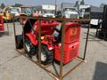 A red 2025 AGT Industrial SDA-140WZ mini loader with large wheels and a front bucket, secured in a metal frame for transport
