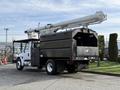 A 2012 International DuraStar 4300 bucket truck with a black body and an extended white boom attached to the rear