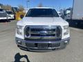 A white 2017 Ford F-150 truck facing forward with a chrome grille and large headlights
