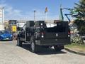 A 2022 Ford F-350 SD truck with a black exterior and utility bed equipped with storage boxes on the sides