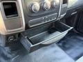 A black dashboard drawer partially extended from the console of a 2015 RAM 4500 featuring control knobs and buttons above it