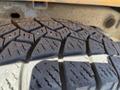 Close-up of a worn tire tread of a 2013 Chevrolet Silverado 1500 showing detailed grooves and patterns