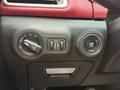 Controls and buttons of a 2016 Maserati Ghibli featuring a start-stop engine button lighting up and various dials for lights and driving settings