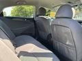 Interior view of a 2015 Hyundai Sonata showing the backseat with two headrests and fabric upholstery