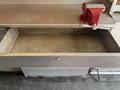 A 2011 Workhorse W62 with an empty metal drawer and a red vice mounted on the table