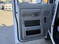 The image shows the interior door of a 2019 Ford E-450 with a gray panel featuring a handle and multiple compartments