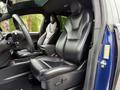 Interior view of a 2020 Tesla Model X featuring black leather seats and a modern steering wheel