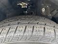 A close-up of a worn tire from a 2014 Honda CR-V displaying tread patterns and some dirt on the surface