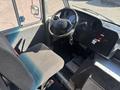 Interior view of a 2012 Ford E-450 showing the driver's seat steering wheel and dashboard controls