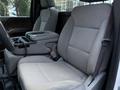 The interior of a 2017 GMC Sierra 3500HD featuring a gray front seat with a center console and armrest