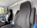 Two black fabric seats with high backs, designed for comfort, positioned in the cab of a vehicle