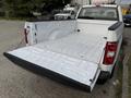A 2018 Ford F-150 with an open truck bed showcasing a clean, empty cargo area without any items or accessories inside