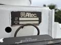 A metal identification tag from an Altec truck mounted on a 2013 Freightliner 114SD displaying job and serial numbers