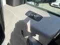 A close-up of the door panel of a 2018 Ford F-150 featuring a window control switch and textured surfaces in gray and black