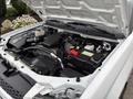 A 2011 Chevrolet Colorado with the hood opened revealing the engine compartment featuring various components and a battery