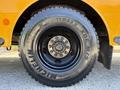 A close-up of a Michelin tire mounted on a 2011 Freightliner B2 featuring the tire size 11R22.5 XDE M/S with a shiny black wheel rim