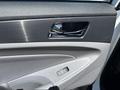 The interior door panel of a 2014 Hyundai Sonata featuring a chrome door handle and a control switch for the power windows